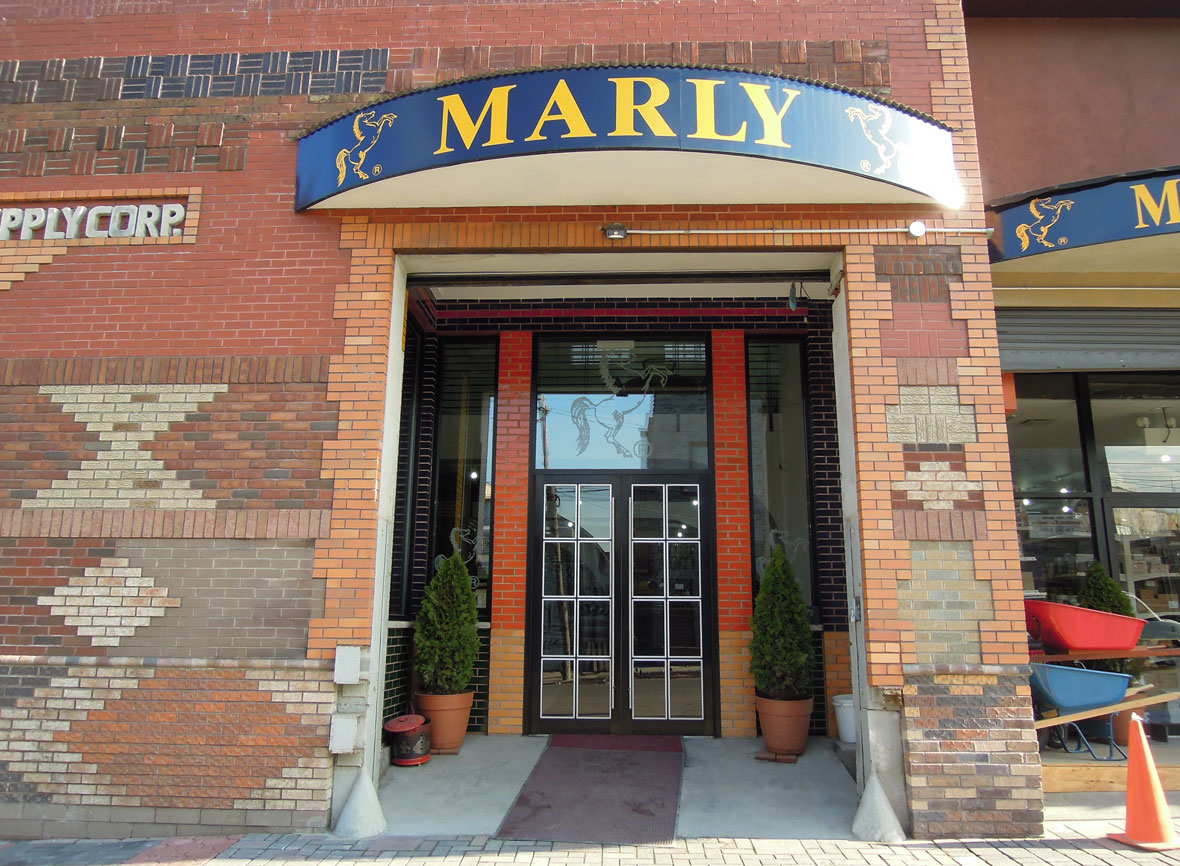 The arched main entrance under the Marly sign