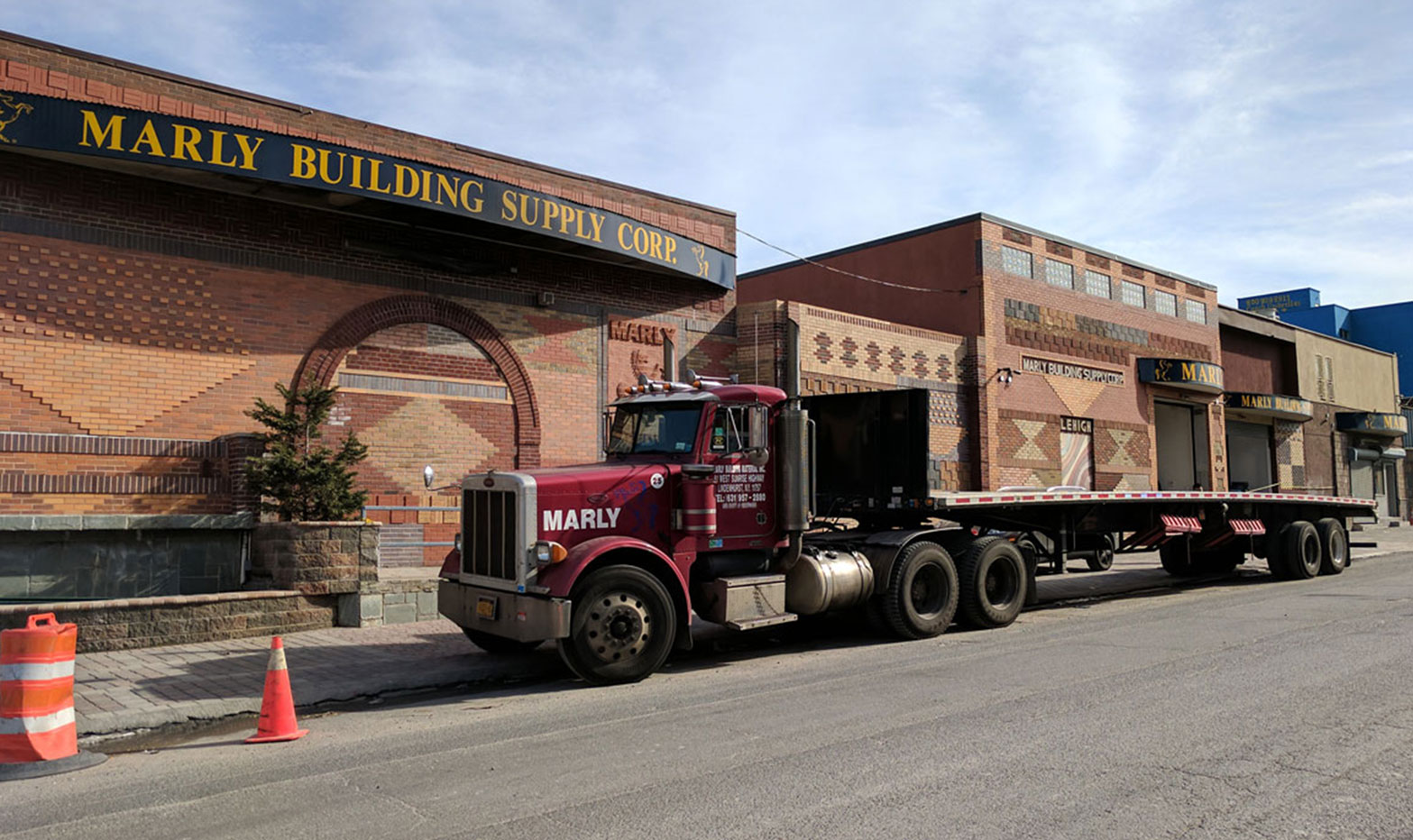 The storefront arch with a truck at the curb